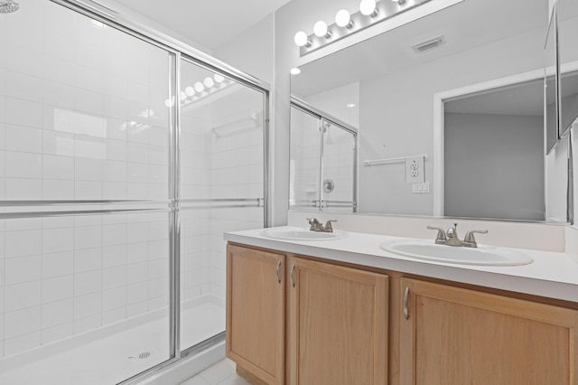 bathroom with vanity and an enclosed shower