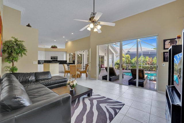 tiled living room with ceiling fan and a towering ceiling