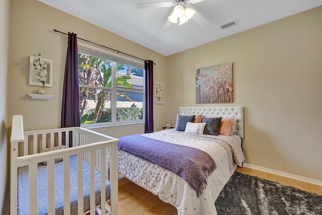 bedroom with ceiling fan and hardwood / wood-style floors