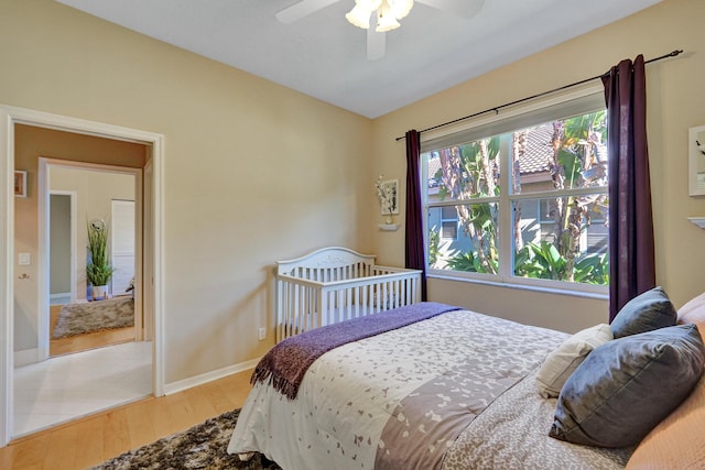 bedroom featuring ceiling fan and light hardwood / wood-style flooring