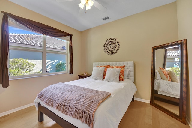 bedroom with ceiling fan and wood-type flooring