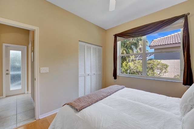 bedroom with ceiling fan, a closet, and light hardwood / wood-style flooring