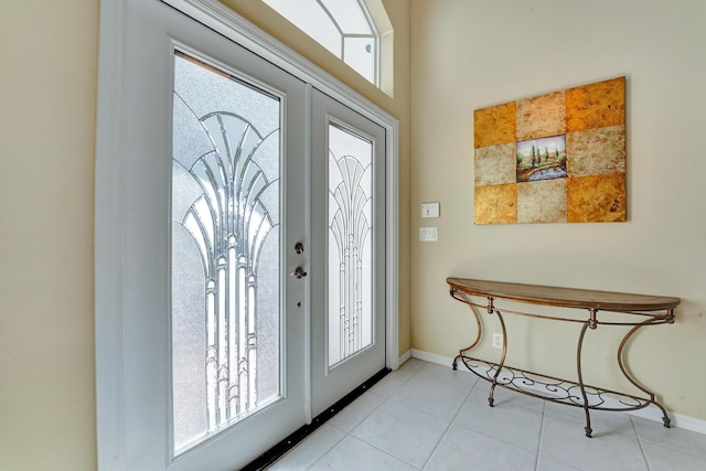 foyer entrance featuring a wealth of natural light, light tile patterned floors, and french doors