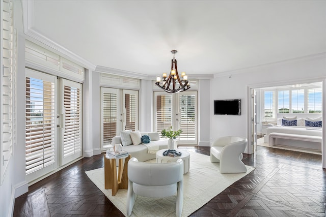 living room featuring a chandelier, dark parquet floors, crown molding, and french doors