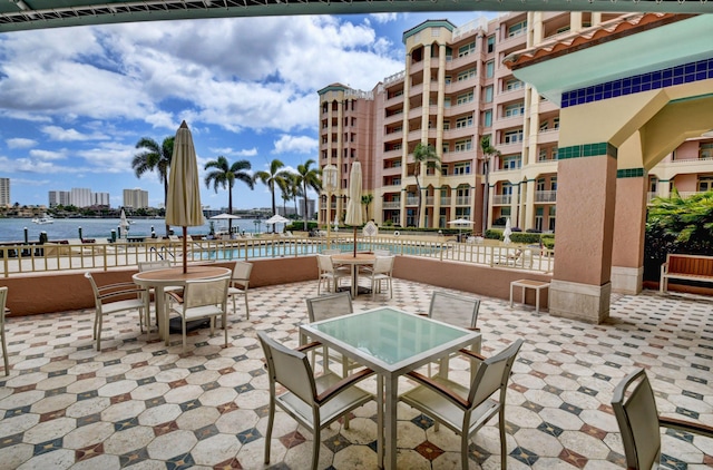 view of patio / terrace featuring a water view and a community pool