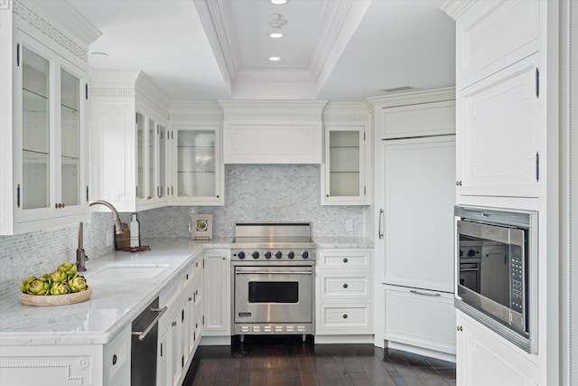 kitchen with light stone counters, stainless steel appliances, sink, dark hardwood / wood-style floors, and white cabinetry