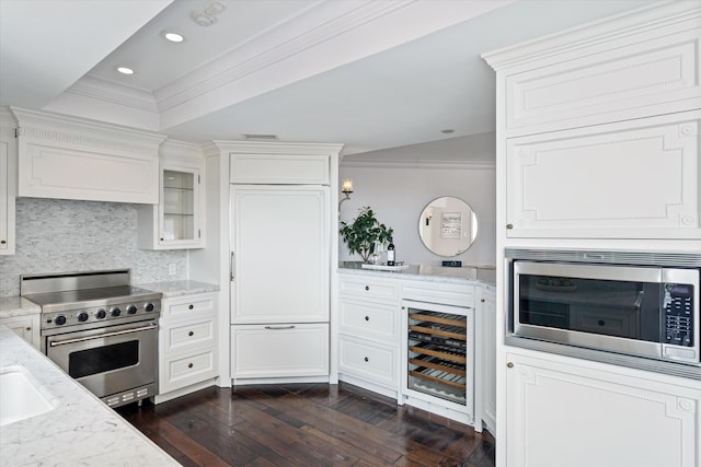 kitchen featuring white cabinetry, stainless steel appliances, beverage cooler, and dark wood-type flooring