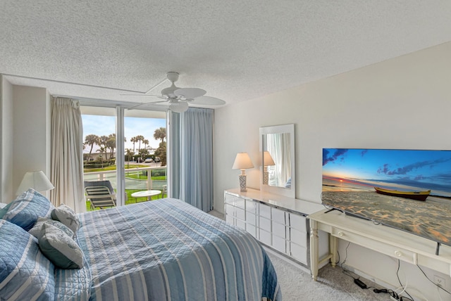 bedroom featuring carpet, ceiling fan, and a textured ceiling