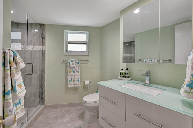 bathroom featuring tile patterned flooring, vanity, toilet, and walk in shower