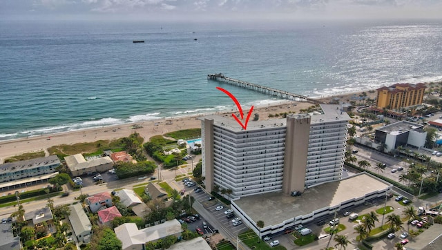 drone / aerial view with a beach view and a water view