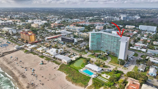 drone / aerial view featuring a beach view and a water view