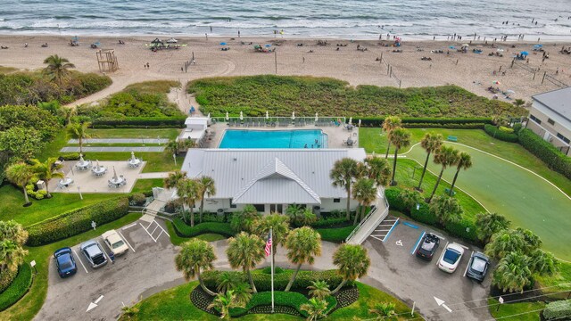 bird's eye view with a water view and a beach view