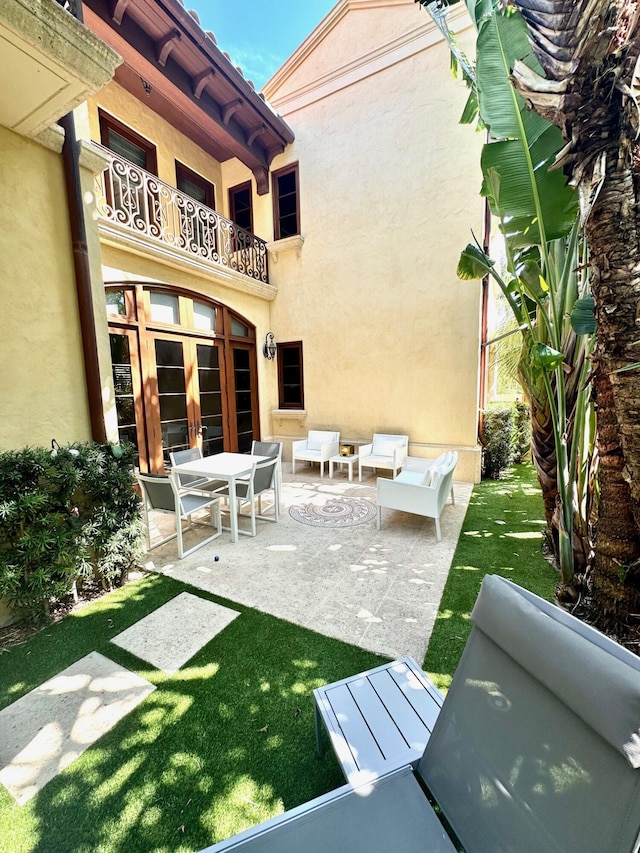 view of patio / terrace with french doors, a balcony, and an outdoor hangout area