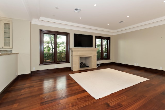 unfurnished living room with crown molding, dark wood-type flooring, and a wealth of natural light