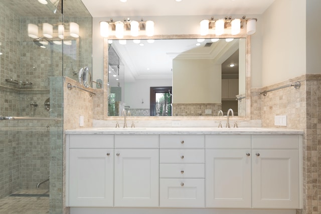 bathroom with vanity, crown molding, and walk in shower