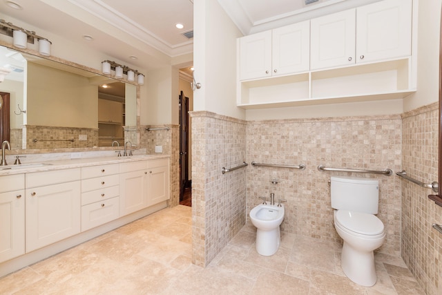 bathroom with tile walls, crown molding, vanity, toilet, and a bidet