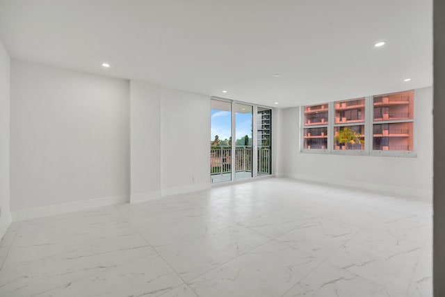 spare room with floor to ceiling windows