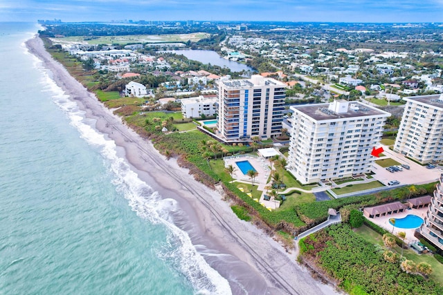 bird's eye view with a water view and a beach view