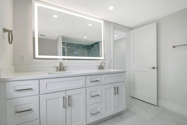 full bath featuring marble finish floor, double vanity, a sink, and a shower stall