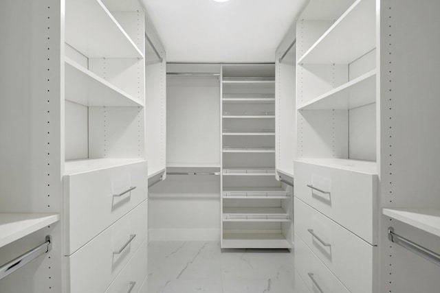 spacious closet with marble finish floor