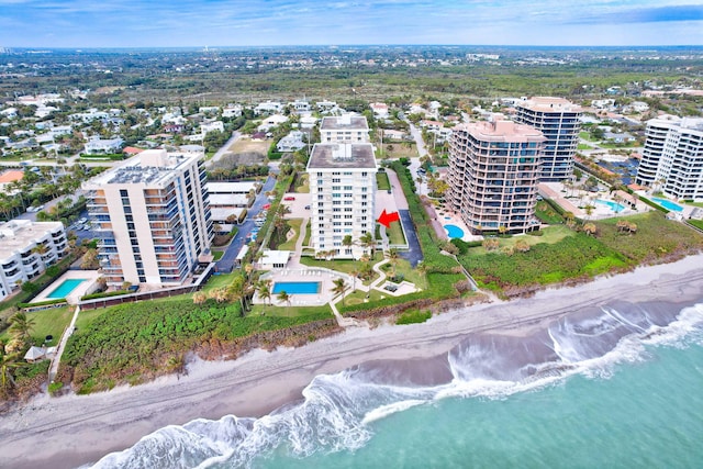 aerial view with a water view and a view of the beach