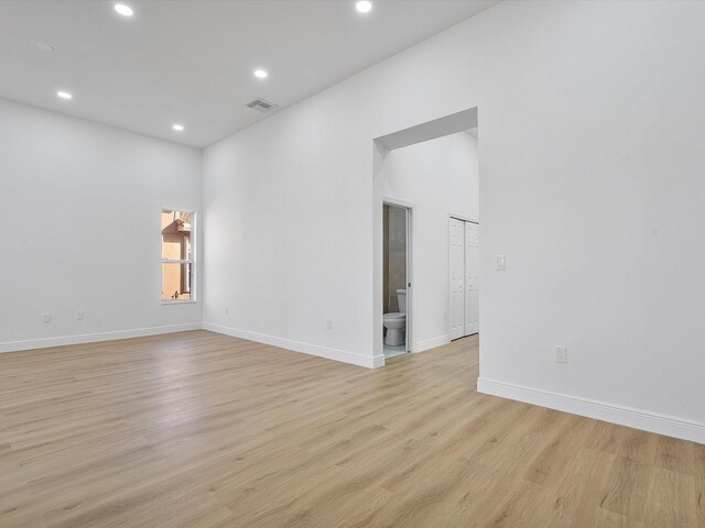 kitchen featuring stainless steel refrigerator, white cabinetry, sink, and light hardwood / wood-style floors