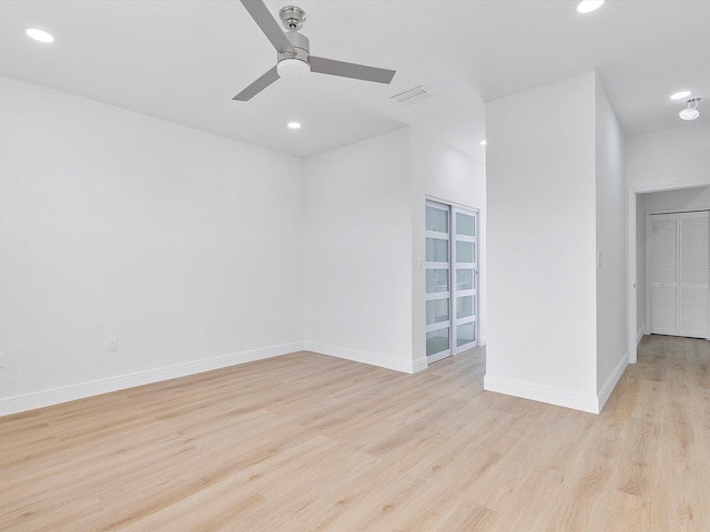 spare room with ceiling fan and light hardwood / wood-style flooring