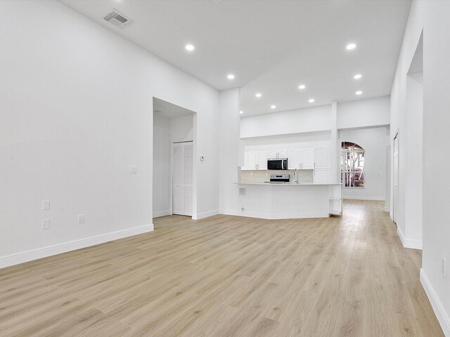 bathroom with hardwood / wood-style floors, tile walls, and shower with separate bathtub