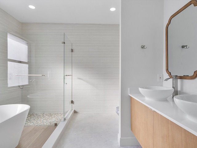 bathroom featuring tile patterned flooring, vanity, and independent shower and bath