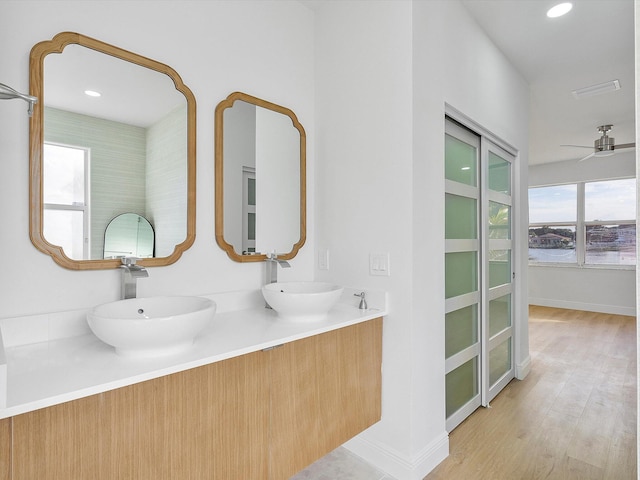 bathroom with hardwood / wood-style floors, vanity, and ceiling fan