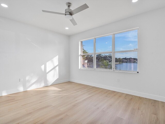 unfurnished bedroom with a closet, light hardwood / wood-style flooring, and ceiling fan