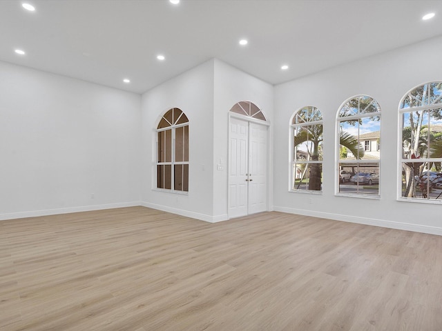 empty room with light hardwood / wood-style flooring