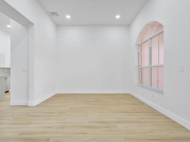 spare room with light hardwood / wood-style flooring