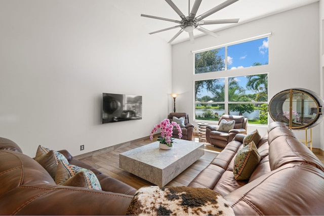 living room with wood-type flooring and ceiling fan