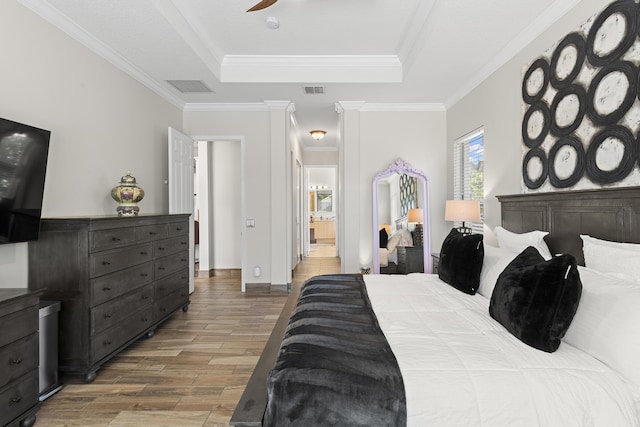 bedroom with a tray ceiling, ceiling fan, and crown molding