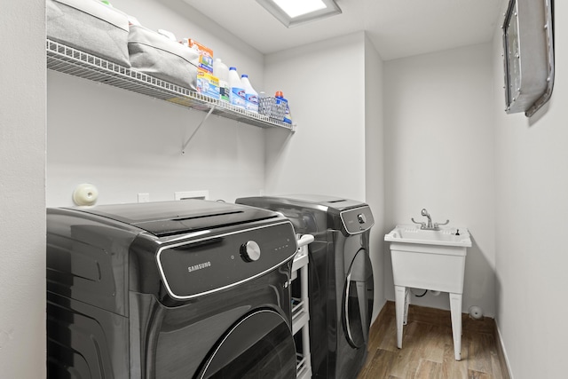 washroom featuring washing machine and dryer and hardwood / wood-style flooring