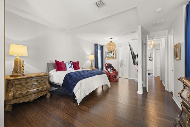 bedroom with dark hardwood / wood-style floors