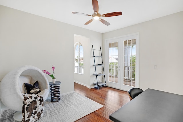 living area with hardwood / wood-style flooring, ceiling fan, and french doors