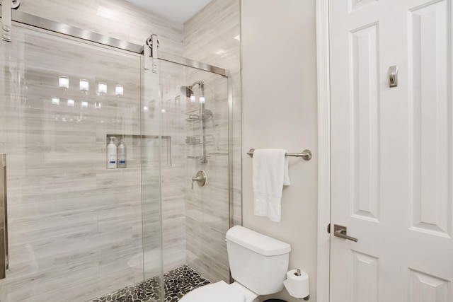 bathroom featuring toilet and walk in shower