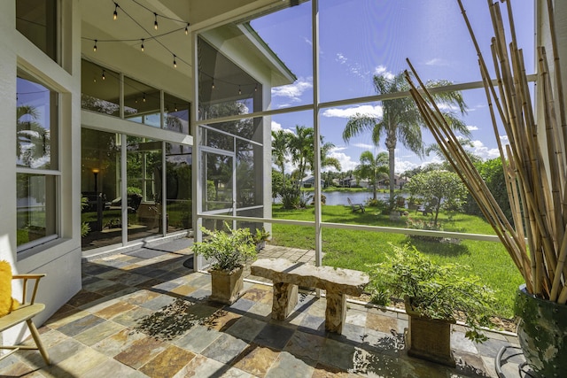 unfurnished sunroom with a water view