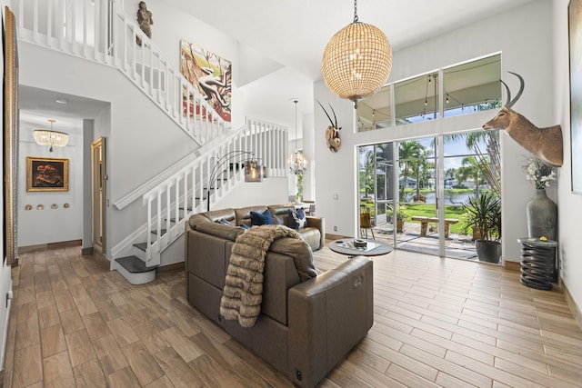 living room with a towering ceiling and a chandelier