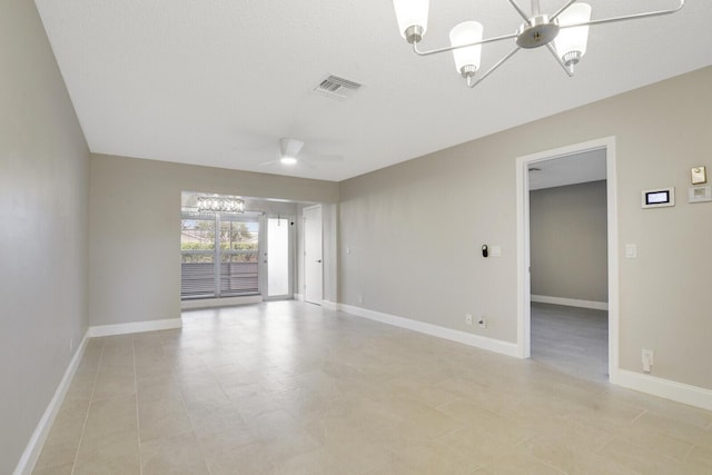 unfurnished room featuring ceiling fan with notable chandelier