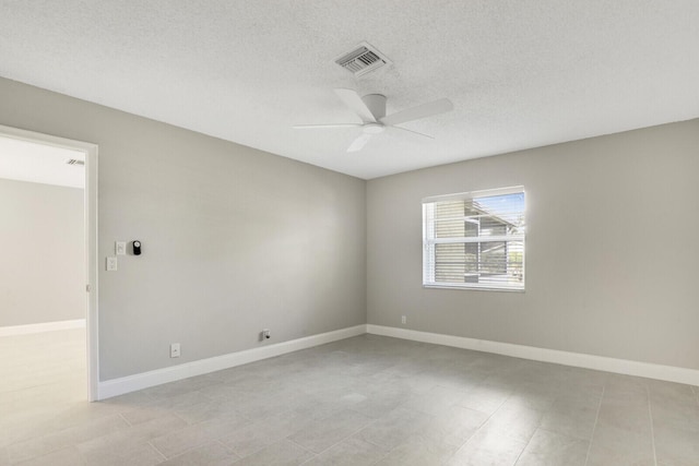 spare room featuring ceiling fan and a textured ceiling