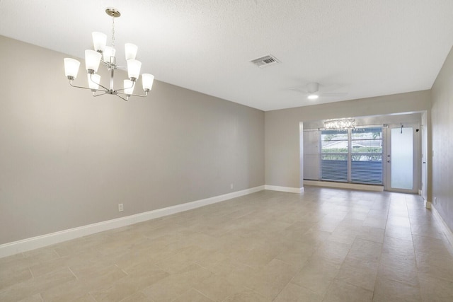 empty room with light tile patterned floors and ceiling fan with notable chandelier