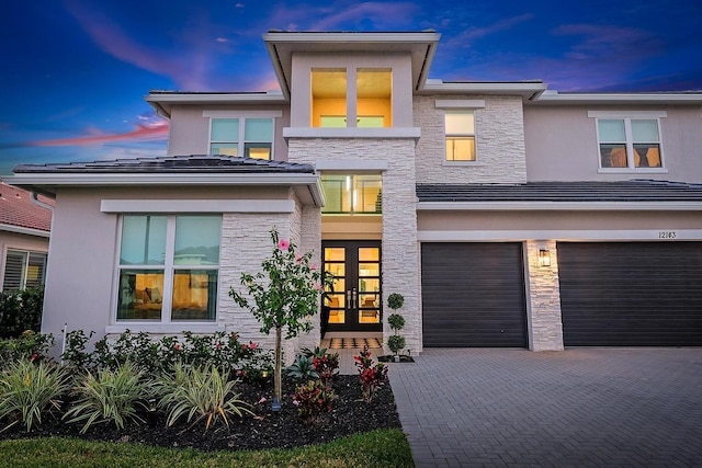 view of front of property featuring a garage and french doors