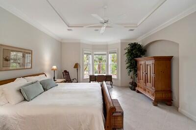 carpeted bedroom with ceiling fan, crown molding, and billiards