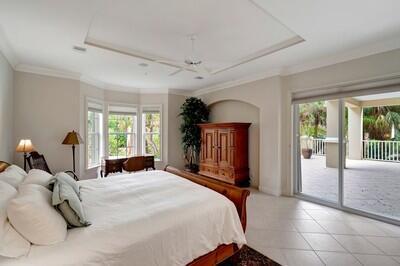 tiled bedroom featuring ceiling fan, crown molding, and access to outside