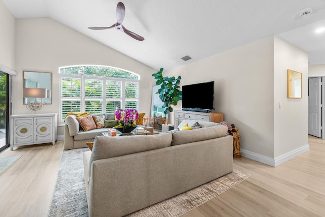 living room with light wood-type flooring, vaulted ceiling, and ceiling fan