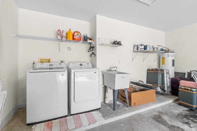 laundry area with washer and dryer, sink, and water heater