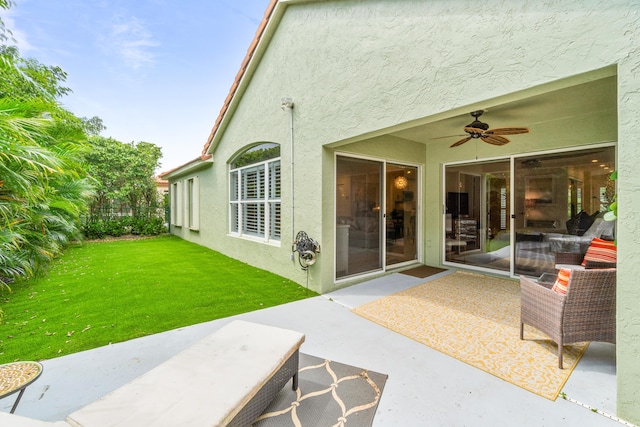 rear view of house with a yard, a patio, and ceiling fan